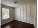 Bright bedroom features a decorative accent wall and a window overlooking the outdoors at 1015 Crest Ridge Sw Pl, Marietta, GA 30060