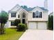 Charming two-story home with manicured lawn, two-car garage, and welcoming curb appeal at 1015 Crest Ridge Sw Pl, Marietta, GA 30060