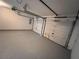 This 2 car garage features an epoxy floor and standard roll up doors at 1015 Crest Ridge Sw Pl, Marietta, GA 30060