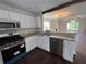 Well-lit kitchen featuring white cabinets, stainless steel appliances, and granite countertops at 1015 Crest Ridge Sw Pl, Marietta, GA 30060