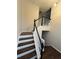 Staircase with wood treads and white risers and black handrail at 1015 Crest Ridge Sw Pl, Marietta, GA 30060