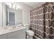 Bathroom with white vanity, updated fixtures, and patterned shower curtain at 1240 Kilmington Ct, Alpharetta, GA 30009