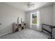 Bedroom with a well-lit window, neutral color scheme, and plush carpet at 1240 Kilmington Ct, Alpharetta, GA 30009