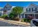Attractive townhome boasts meticulous landscaping, charming shutters, and designated parking spaces at 1240 Kilmington Ct, Alpharetta, GA 30009