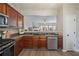 Stylish kitchen boasts stainless steel appliances, elegant countertops, and an open view to the living area at 1240 Kilmington Ct, Alpharetta, GA 30009