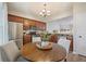 Cozy eat-in kitchen showcasing stainless steel appliances, wooden cabinets, and adjacent living area at 1240 Kilmington Ct, Alpharetta, GA 30009
