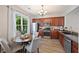Bright kitchen showcasing stainless steel appliances, rich wood cabinets, and a cozy breakfast area at 1240 Kilmington Ct, Alpharetta, GA 30009