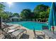 Resort-style swimming pool surrounded by lounge chairs and lush landscaping, perfect for relaxation and recreation at 1240 Kilmington Ct, Alpharetta, GA 30009