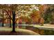 Picturesque lakeside scene with autumn foliage and reflections in the calm water at 2075 Six Branches, Roswell, GA 30076