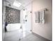 Bright bathroom featuring a soaking tub, patterned tile accent wall, and glass-enclosed shower at 2075 Six Branches, Roswell, GA 30076