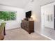Bedroom featuring a window with natural light and an ensuite bathroom with a glass shower at 2075 Six Branches, Roswell, GA 30076