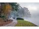 Foggy scenic path featuring a deer surrounded by trees, foliage, and landscaping at 2075 Six Branches, Roswell, GA 30076