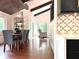 Open-concept dining room with modern chandelier and hardwood floors at 2075 Six Branches, Roswell, GA 30076