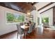 Dining room with hardwood floors, a stylish chandelier, and large windows overlooking the backyard at 2075 Six Branches, Roswell, GA 30076
