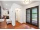 Bright entryway with hardwood floors, textured glass double doors, and a comfortable bench at 2075 Six Branches, Roswell, GA 30076
