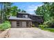 Modern two-story home with a well-manicured front lawn and a spacious two-car garage at 2075 Six Branches, Roswell, GA 30076