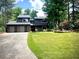 Modern two-story home with a well-manicured front lawn and a spacious two-car garage at 2075 Six Branches, Roswell, GA 30076