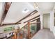 Bright hallway with skylight, exposed beams, hardwood floors and view of dining area at 2075 Six Branches, Roswell, GA 30076