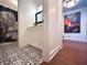 Hallway shot leading to a stylish bathroom with black and white patterned tile at 2075 Six Branches, Roswell, GA 30076