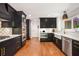 Spacious kitchen with stainless steel appliances, black cabinetry and hardwood floors at 2075 Six Branches, Roswell, GA 30076