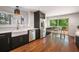 Modern kitchen with stainless steel appliances, sleek black cabinetry, and hardwood floors at 2075 Six Branches, Roswell, GA 30076