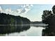A serene lake with reflections of the surrounding trees at 2075 Six Branches, Roswell, GA 30076