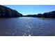 A picturesque view of the calm lake waters, reflecting the clear blue sky at 2075 Six Branches, Roswell, GA 30076