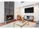 Living room showcasing a stone fireplace, hardwood floors, and stylish furnishings at 2075 Six Branches, Roswell, GA 30076