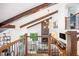 Overhead view of a well-lit living room featuring vaulted ceilings, fireplace, and a staircase at 2075 Six Branches, Roswell, GA 30076