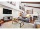 Spacious living room with vaulted ceilings, exposed beams, staircase, and hardwood floors at 2075 Six Branches, Roswell, GA 30076
