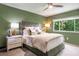 The primary bedroom has natural light from the window and is styled with muted colors at 2075 Six Branches, Roswell, GA 30076