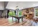 Spacious rec room featuring a pool table, stone fireplace, and access to the outdoors at 2075 Six Branches, Roswell, GA 30076