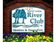 Martin's Landing River Club welcome sign with colorful flowerbed at entrance, a friendly introduction to the community at 2075 Six Branches, Roswell, GA 30076