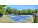 Well-maintained tennis courts provide ample space for recreational play and competitive matches in a beautiful setting at 2075 Six Branches, Roswell, GA 30076