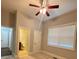 Bedroom with large bright window, carpet flooring, ceiling fan and access to bathroom at 3400 Suwanee Creek Rd, Suwanee, GA 30024