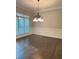 Dining room with hardwood floors, chandelier, wainscoting and large window with shutters at 3400 Suwanee Creek Rd, Suwanee, GA 30024