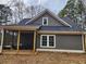 Home exterior with screen porch, wood siding and wooded backdrop at 40 Luther Knight Se Rd, Cartersville, GA 30121