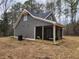 Home exterior featuring a screened porch, wood siding and wooded backdrop at 40 Luther Knight Se Rd, Cartersville, GA 30121