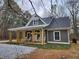 Gray home with a charming front porch featuring rocking chairs and a well-manicured lawn at 40 Luther Knight Se Rd, Cartersville, GA 30121