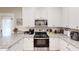 Modern kitchen featuring white cabinets, granite countertops, and stainless steel appliances at 40 Luther Knight Se Rd, Cartersville, GA 30121