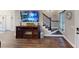 Living room with hardwood flooring, fireplace entertainment center, and staircase to upper floors at 40 Luther Knight Se Rd, Cartersville, GA 30121