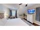 Bright main bedroom featuring hardwood flooring, dresser, ceiling fan, and television at 40 Luther Knight Se Rd, Cartersville, GA 30121