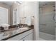 Well-lit bathroom featuring a granite countertop, mirrored vanity, and a shower-tub combination at 1421 Peachtree Ne St # 211, Atlanta, GA 30309