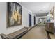 Elegant hallway features modern art and a seating bench next to a mirrored elevator entrance at 1421 Peachtree Ne St # 211, Atlanta, GA 30309