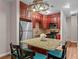 Well-equipped kitchen with cherry cabinets, stainless steel appliances, and cozy breakfast bar seating at 1421 Peachtree Ne St # 211, Atlanta, GA 30309