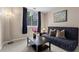 Neutral living room featuring a comfortable blue sofa and stylish decor at 1421 Peachtree Ne St # 211, Atlanta, GA 30309