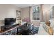 Well-lit living room featuring a large window, stylish rug, and comfortable seating at 1421 Peachtree Ne St # 211, Atlanta, GA 30309