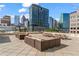 Expansive rooftop terrace with comfortable seating areas and picnic tables perfect for gatherings at 1421 Peachtree Ne St # 211, Atlanta, GA 30309