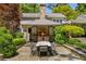 Outdoor fireplace and dining area in a beautifully landscaped backyard at 2890 Howell Mill Rd, Atlanta, GA 30327