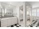 Elegant bathroom with marble shower, white vanity, and unique black and white checkered floors at 2890 Howell Mill Rd, Atlanta, GA 30327
